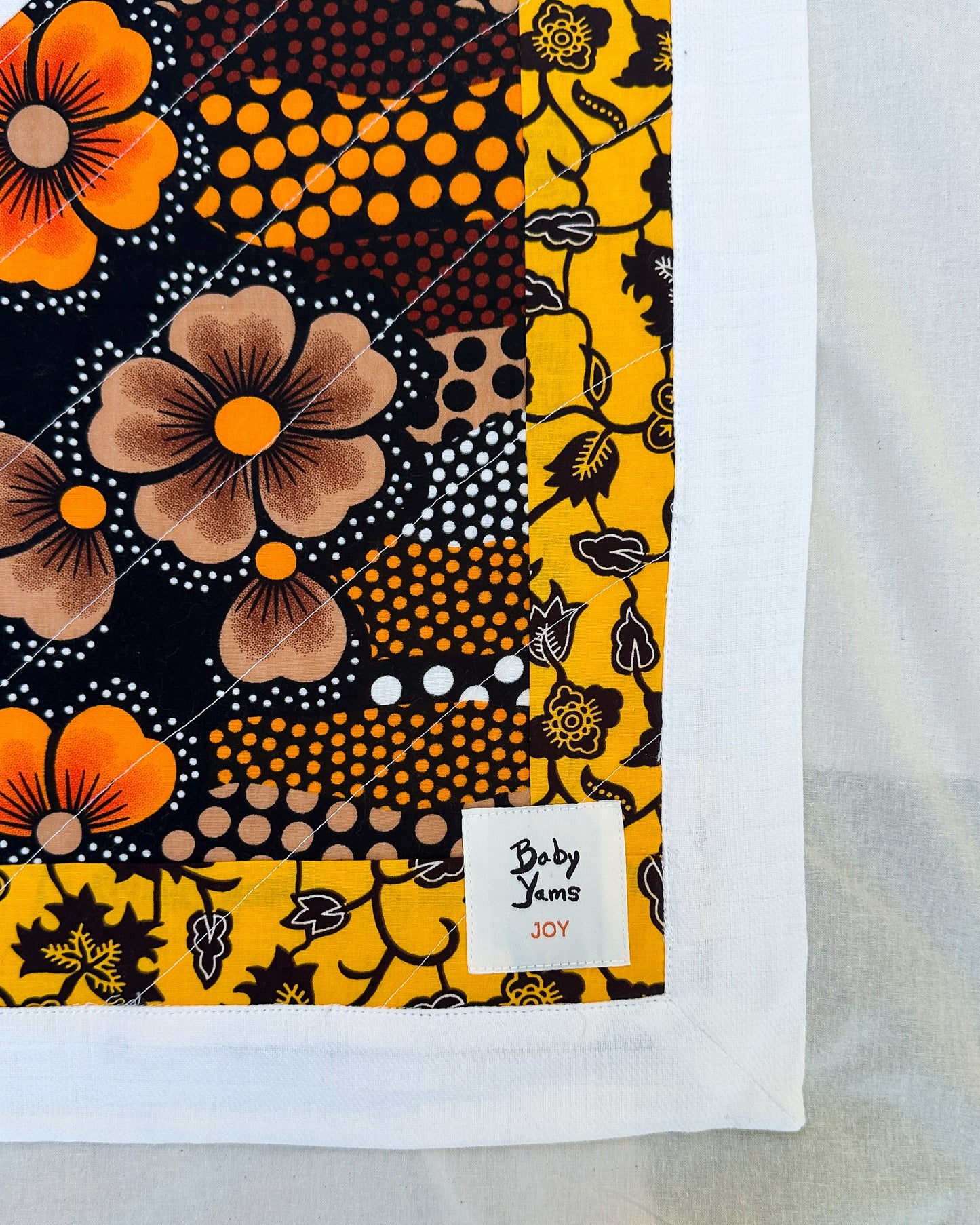 Joy Baby Quilt - Yellow + Orange Batik Flowers